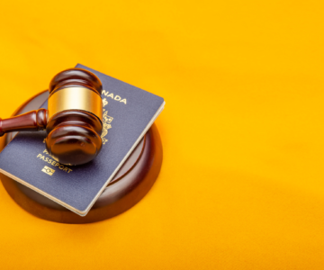 A court legal hammer on a passport and orange background images used for article on Immigration Canada IRCC